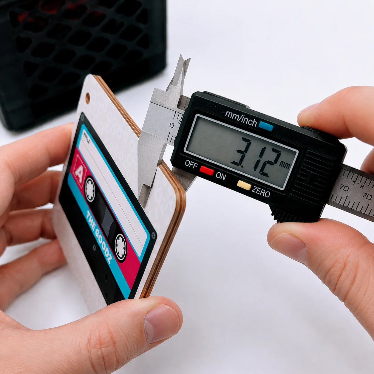 Digital calipers measuring the thickness of a Custom Goodz card at 3.12mm.